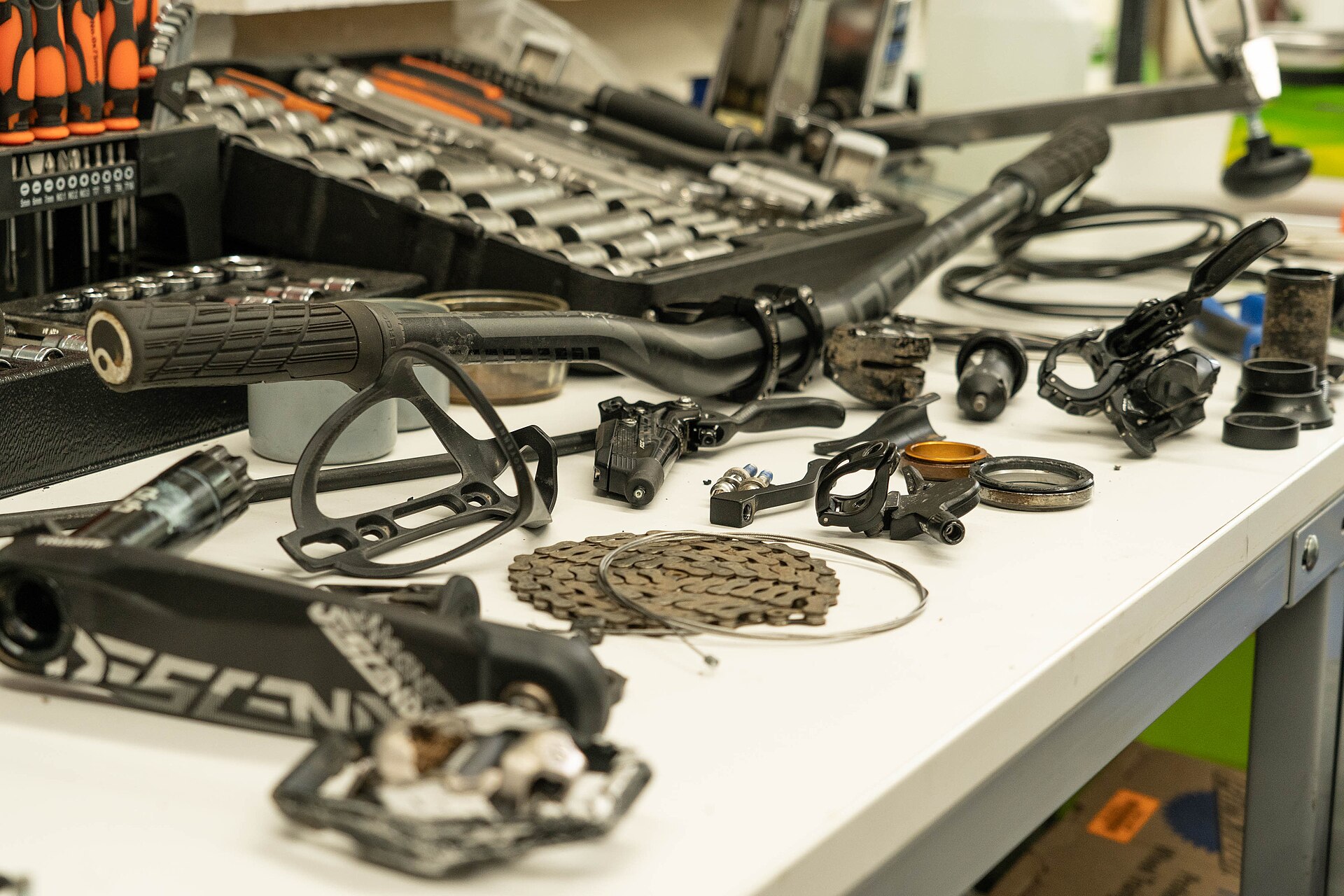 Bicycle parts arranged on a repair workbench